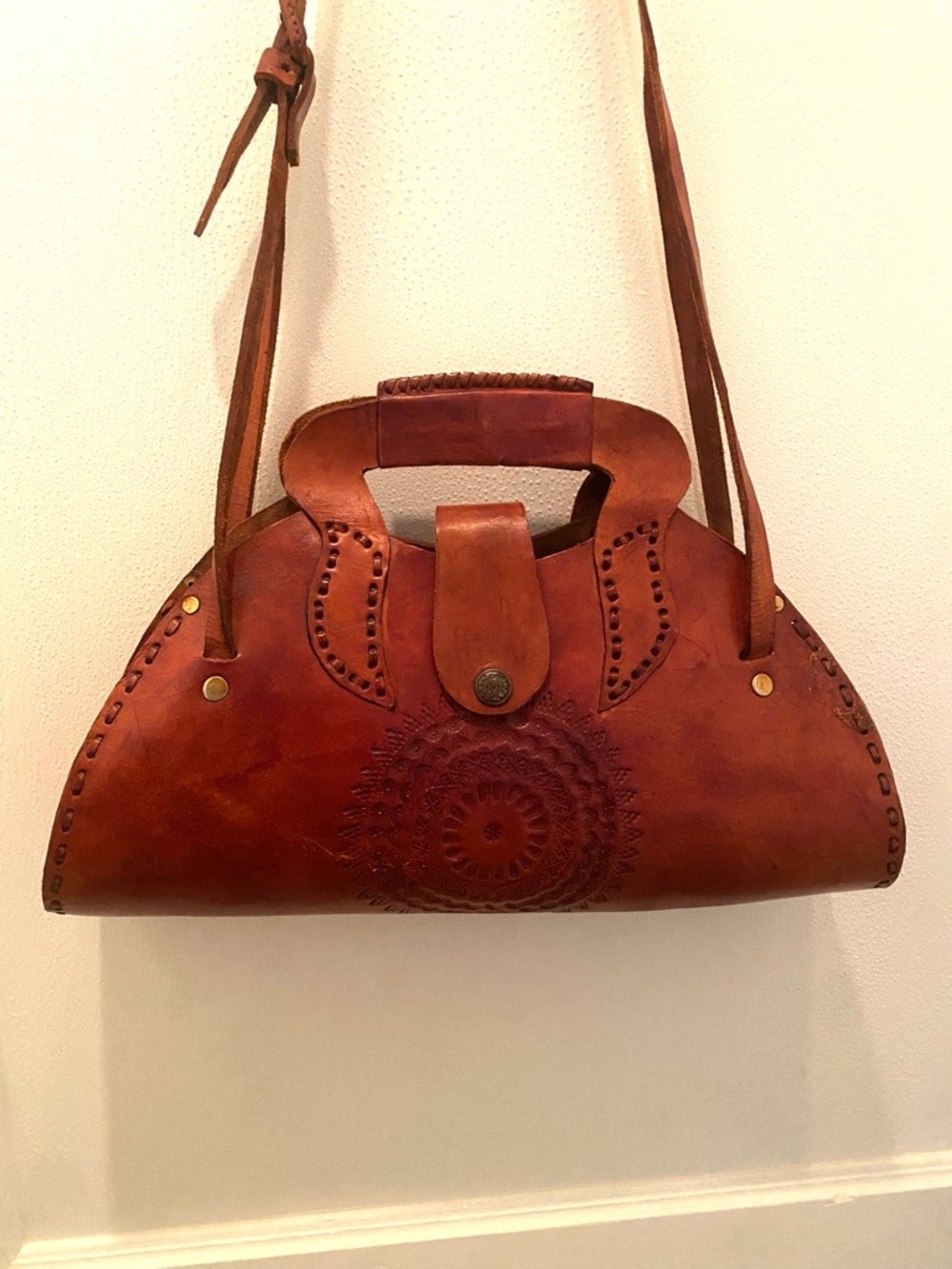 Handcrafted Brown Leather Shoulder Bag with Braided Handle and Embossed Motif